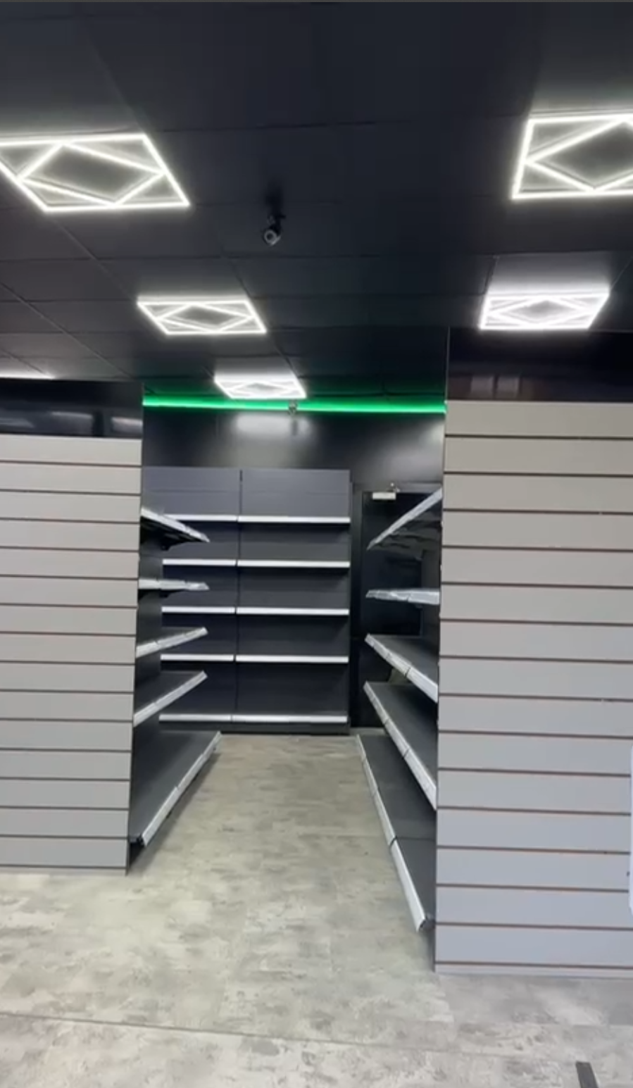 Wall shelving installed in a retail shop interior showing full wall bay display system