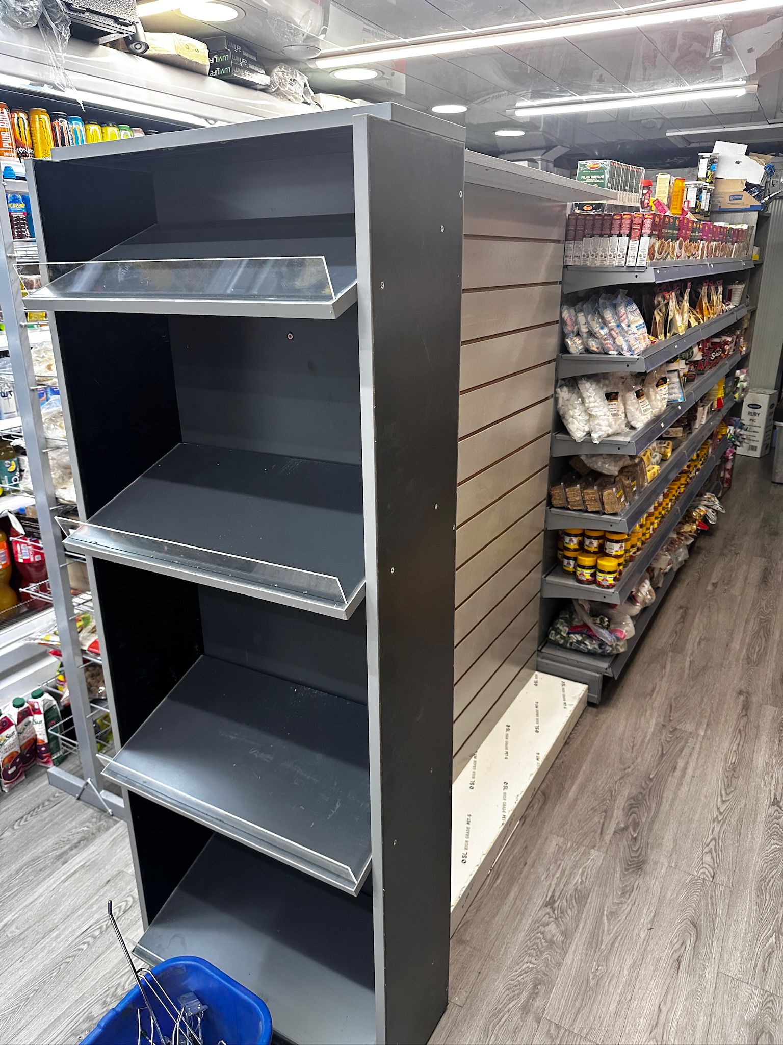 Retail wall shelving example with adjustable shelves stocked with products